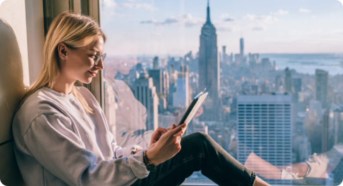 Woman sitting in window reading
