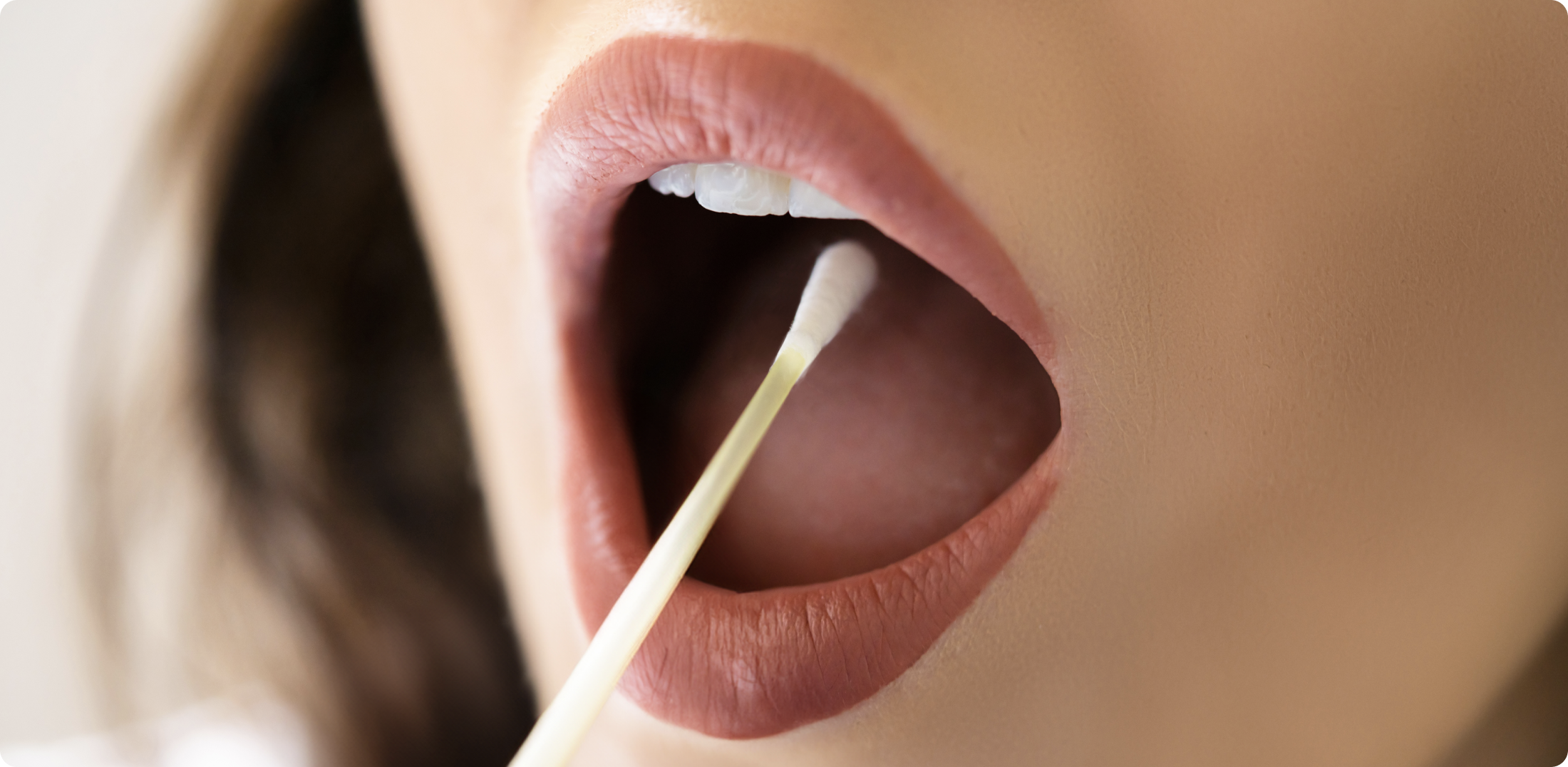 Person taking a sample with a cotton bud