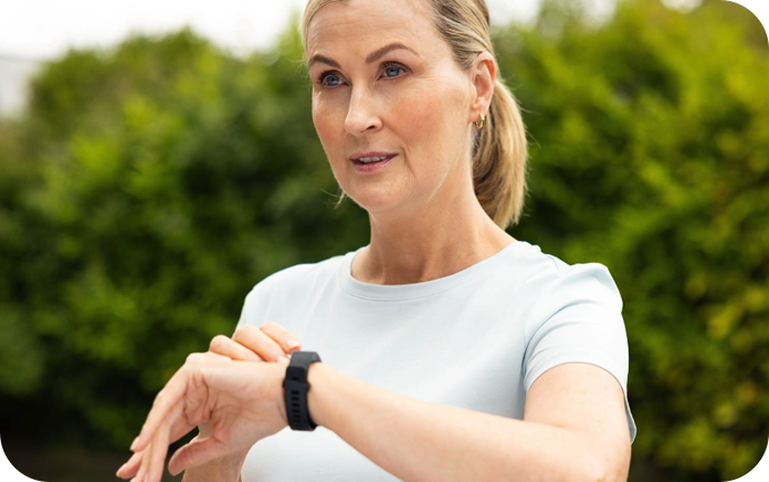 Woman outside, looking at her smart watch
