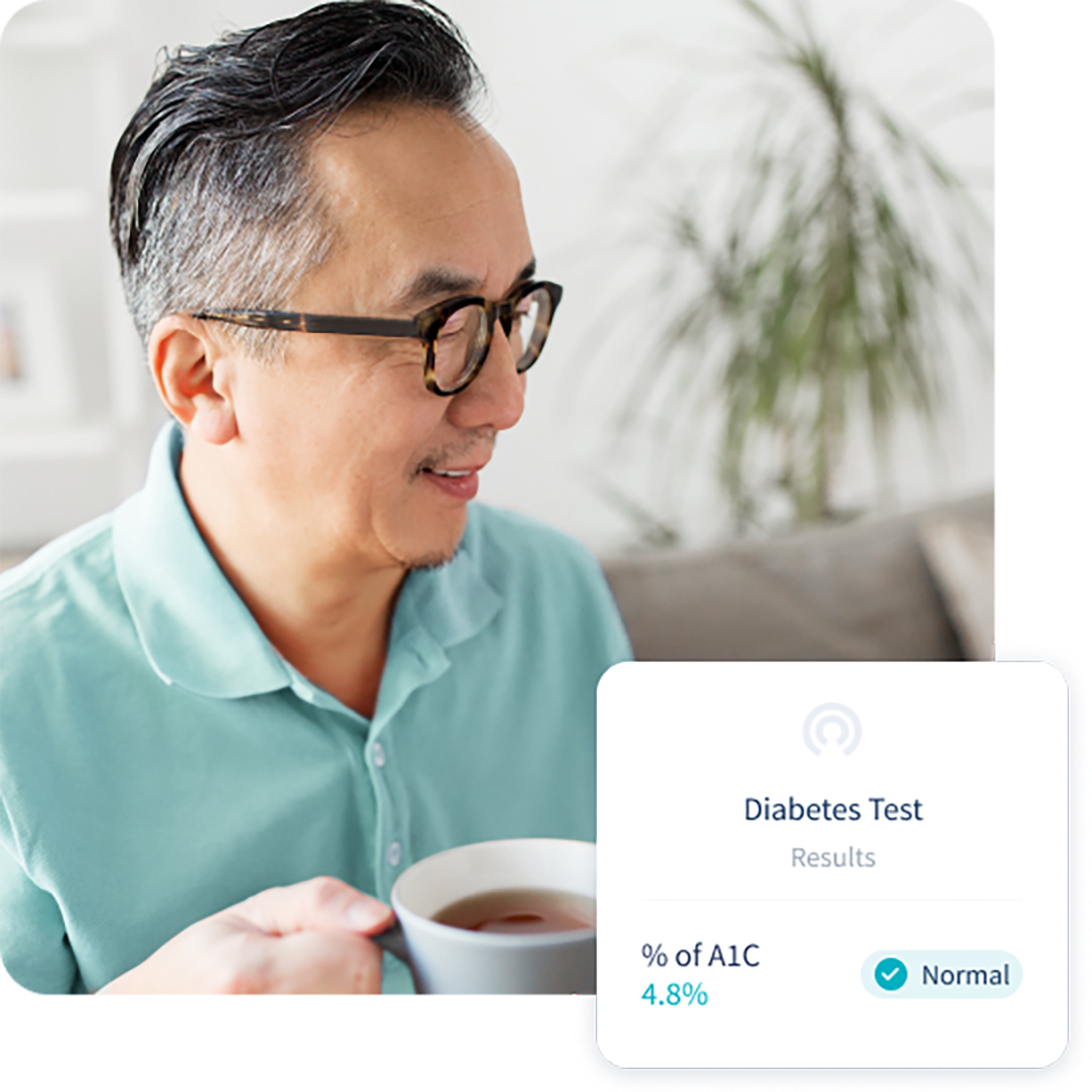 Older man having a cup of tea, with a phone pop-up that reads "Diabetes, percentage of A1C, Normal".