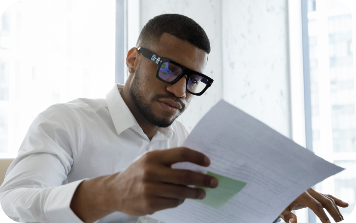 Man reviewing documents in an office setting.