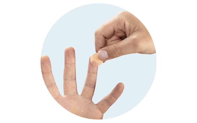 Right hand applying bandage to the tip of the ring finger on the left hand.