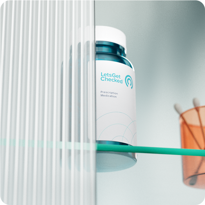 LetsGetChecked branded pill bottle on a glass surface. LetsGetChecked branded pill bottle on a glass surface.