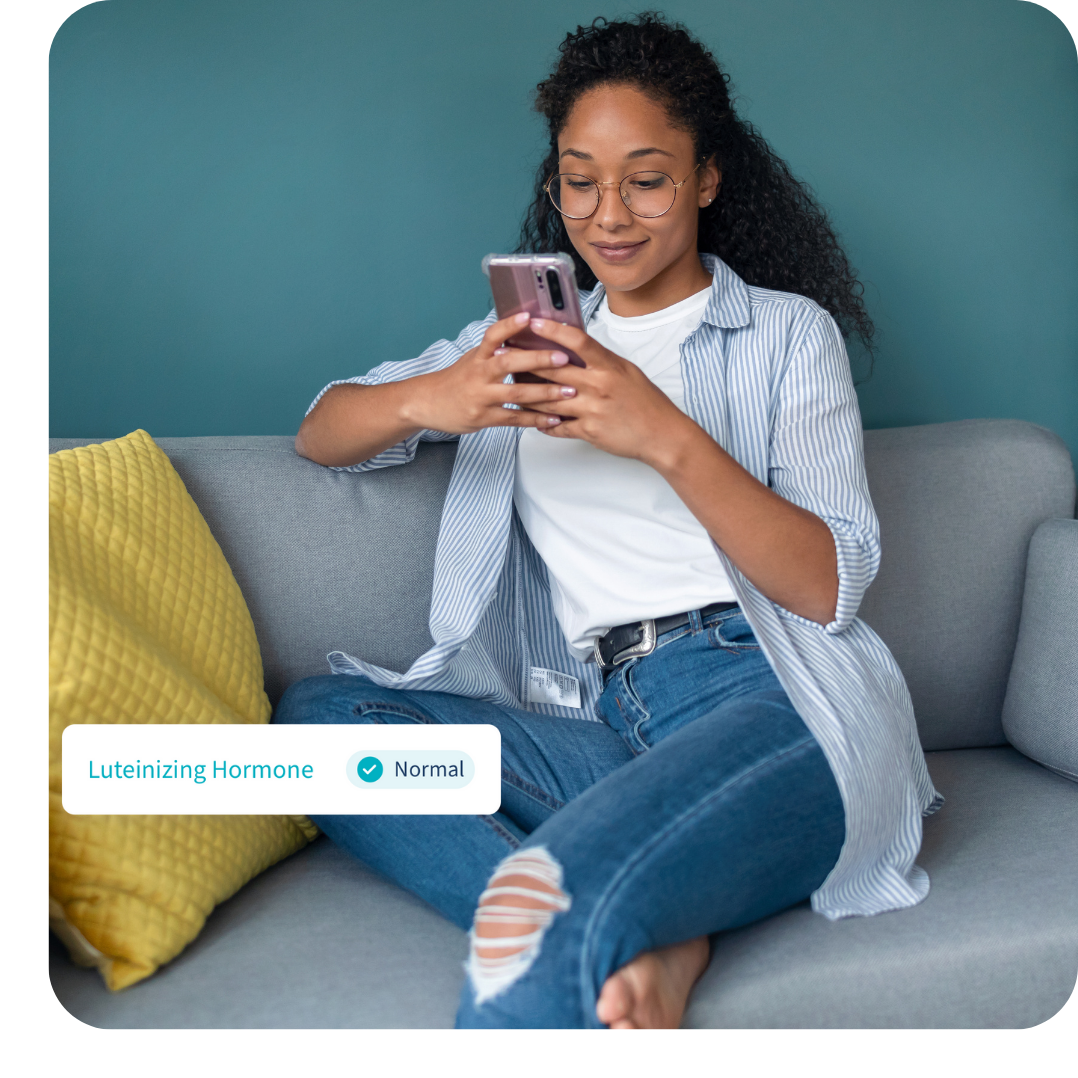 Woman sitting on sofa looking at results on phone