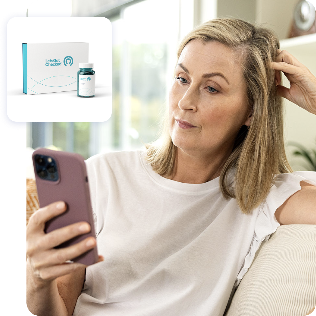 Woman using her smartphone to view a LetsGetcChecked testing kit.