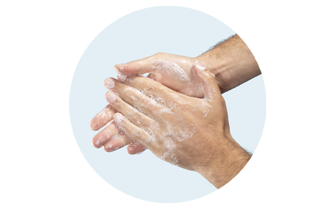 Hands being washed with soap.