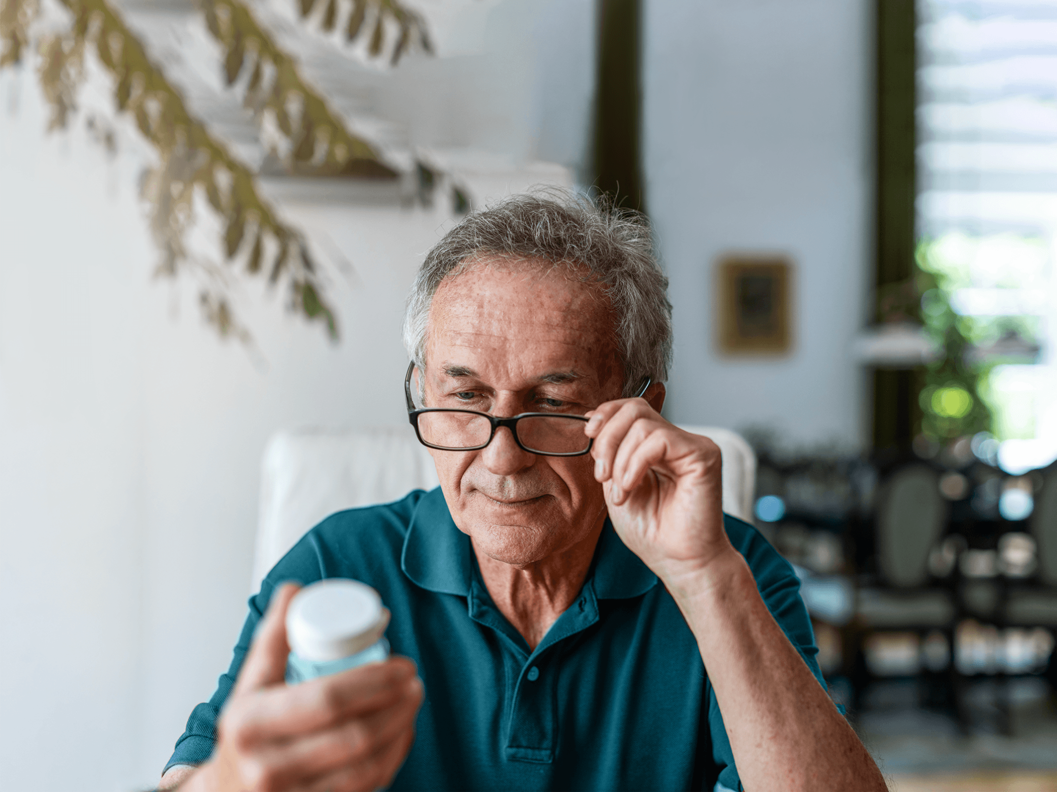 Man looking at pill bottle