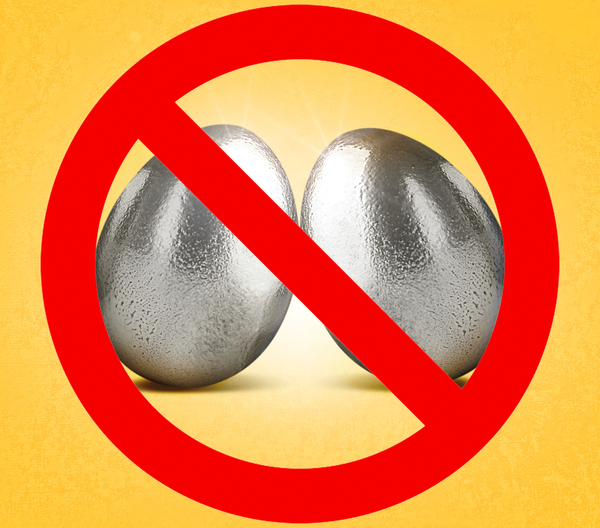Egg-shaped steel balls stand behind a red 'forbidden' sign
