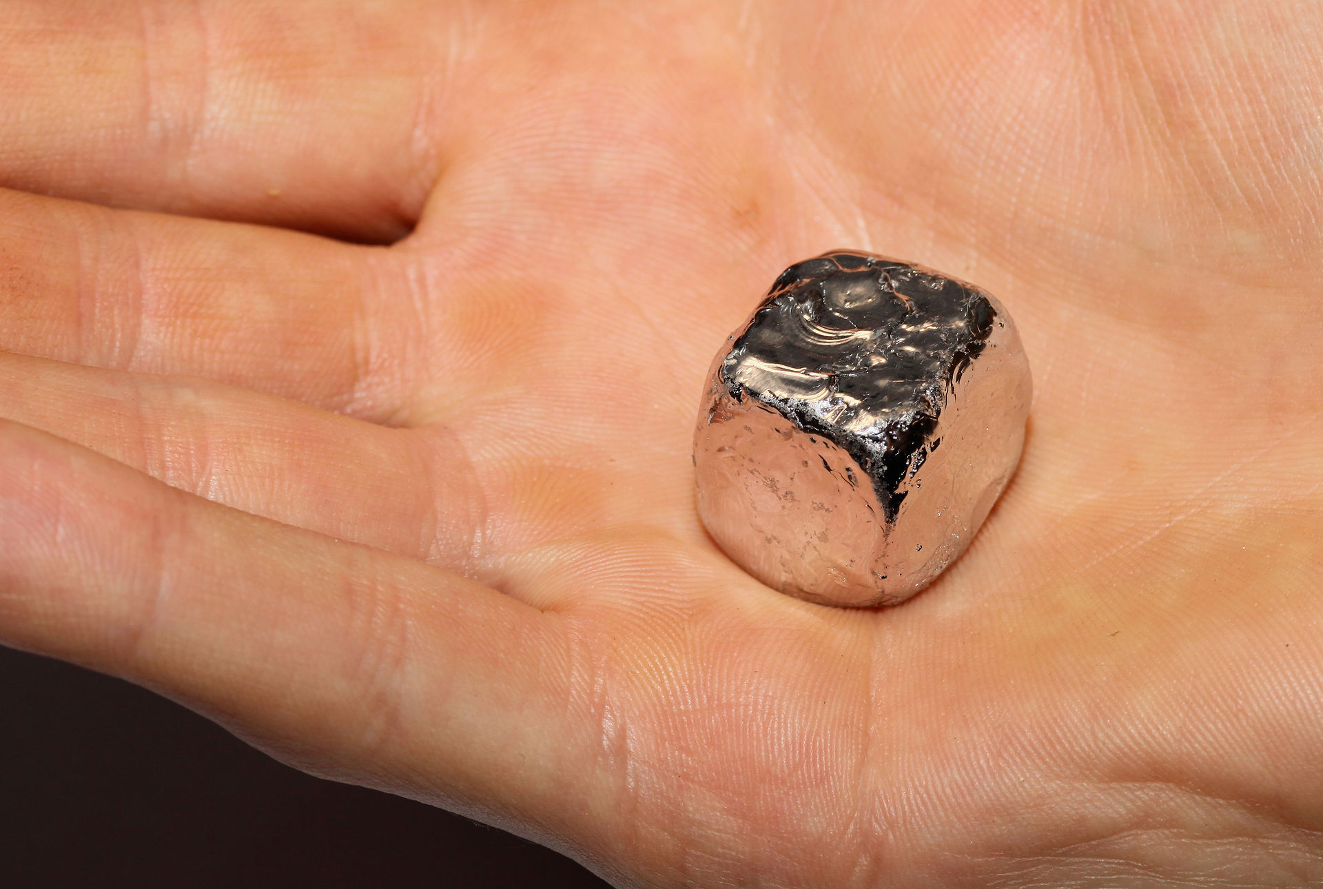 a hand holding a small rock