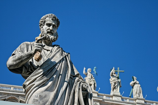 a statue of a person holding a cross