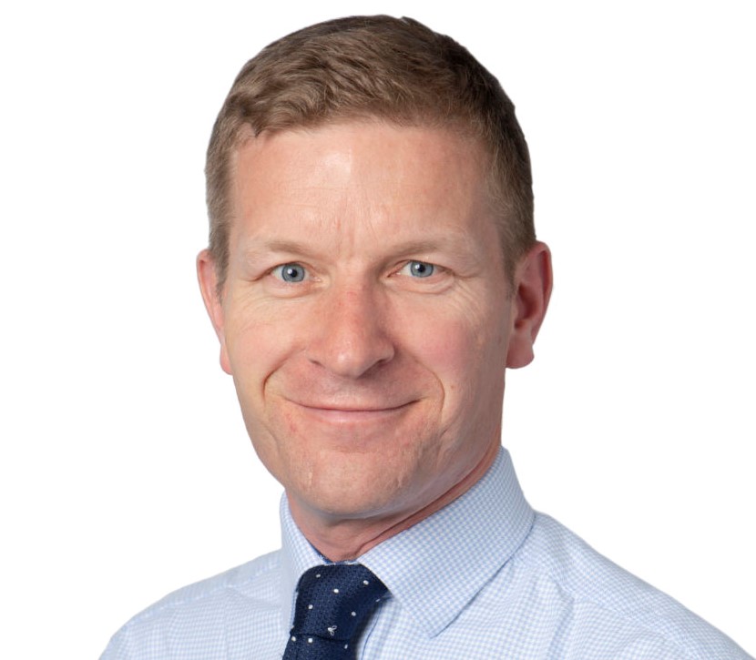 a man wearing a blue shirt and blue tie