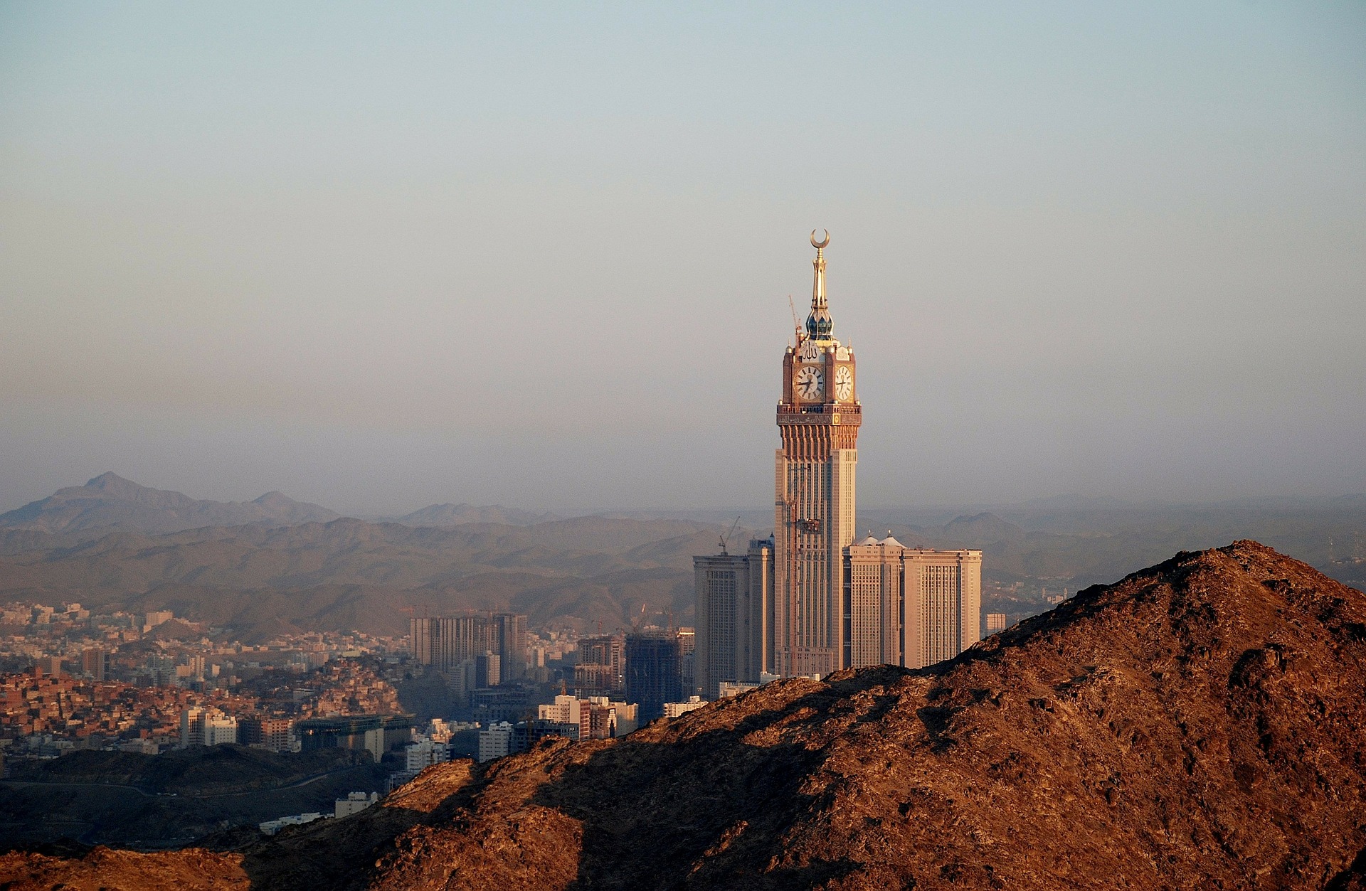 a tall building with a city in the background