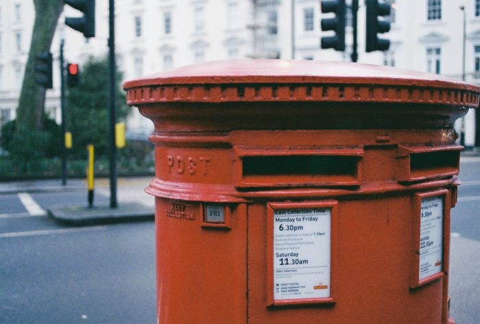 a red mailbox on the street