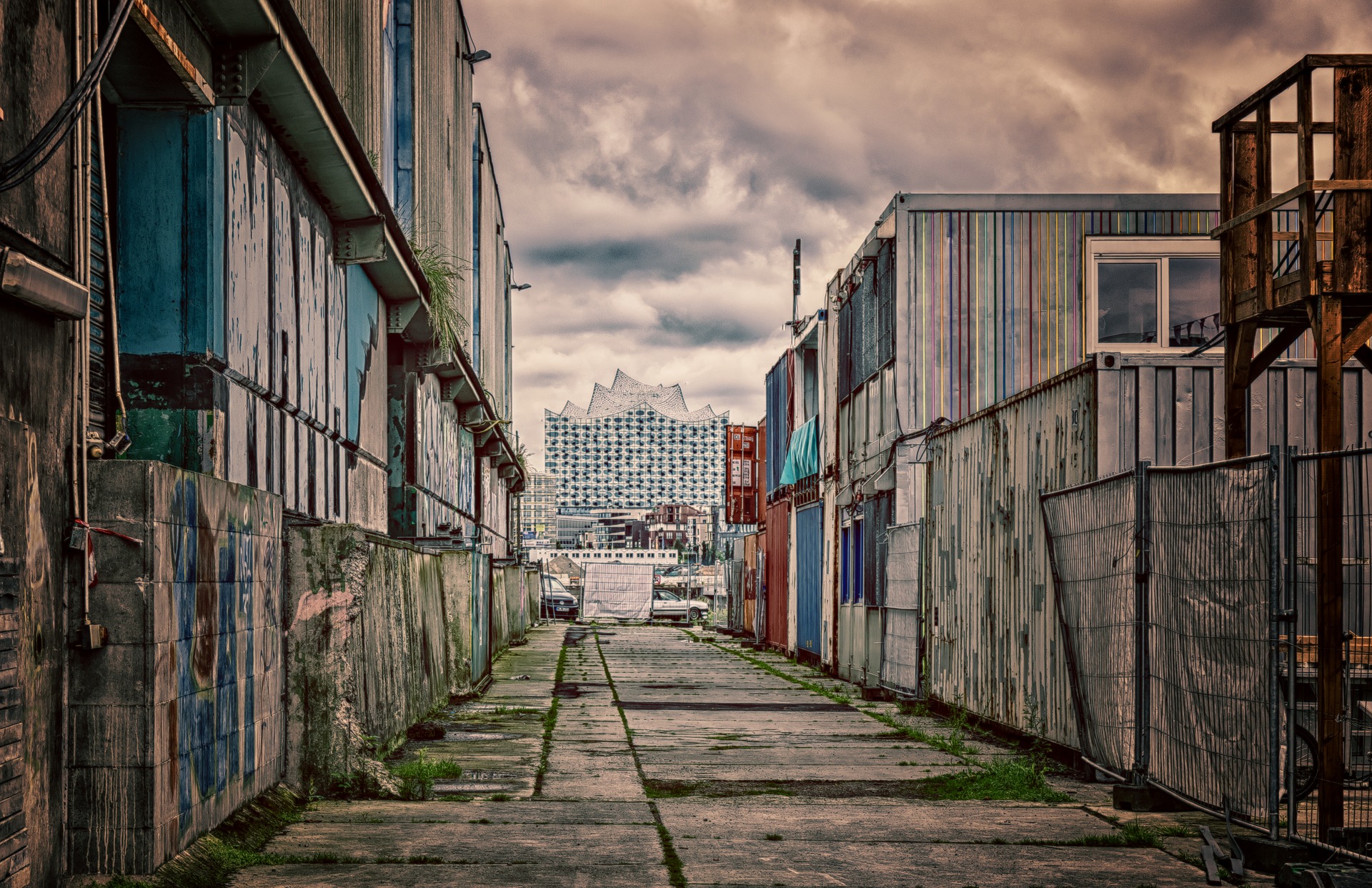 a street with buildings and a fence