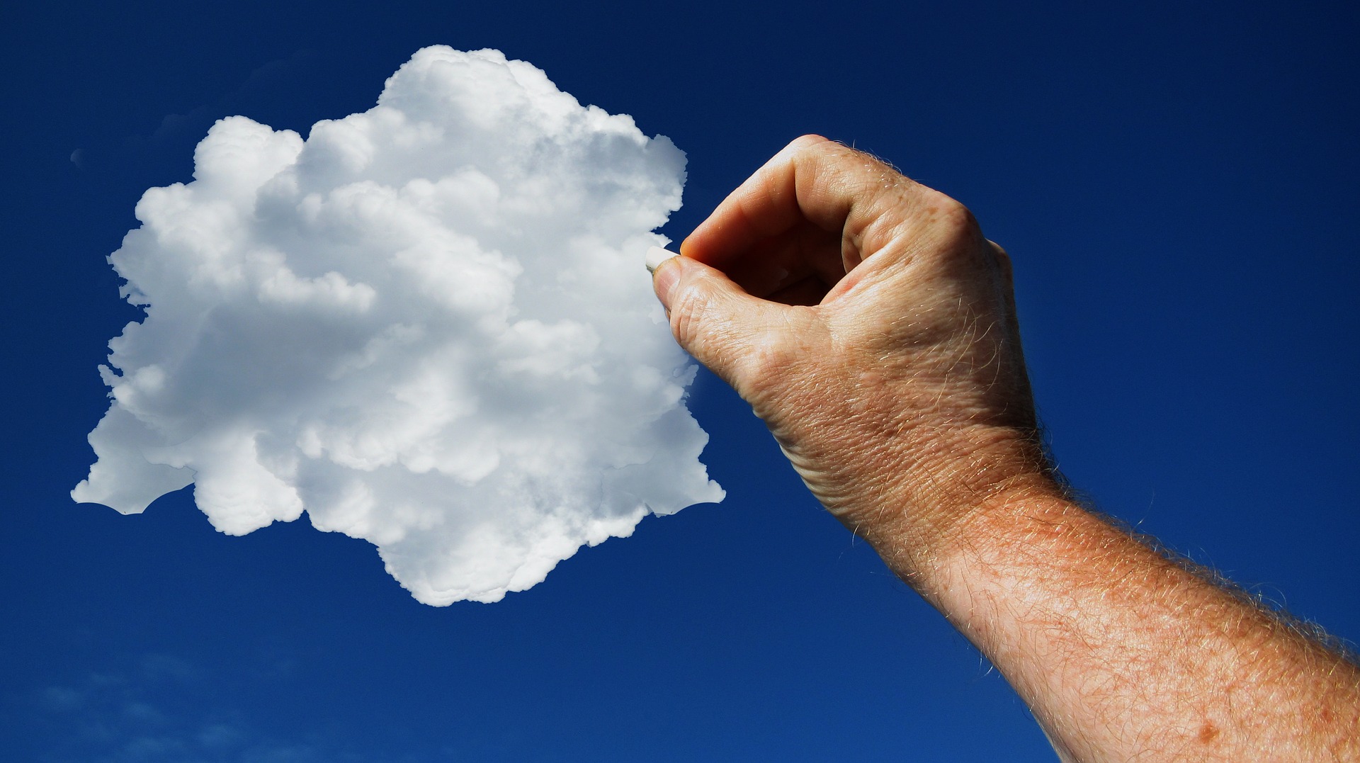 a hand holding a cloud