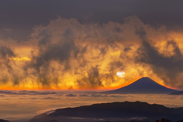 a volcano with a cloud of smoke coming out of it