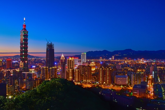 a city with tall buildings and a body of water in the background