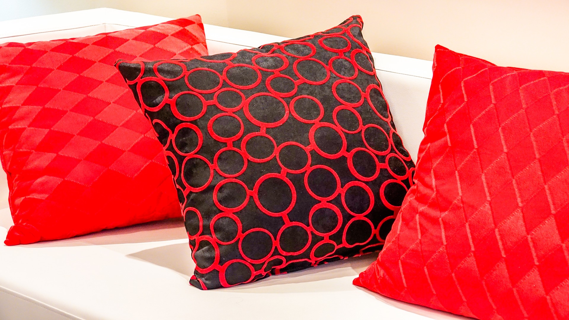 a red pillow on a white surface