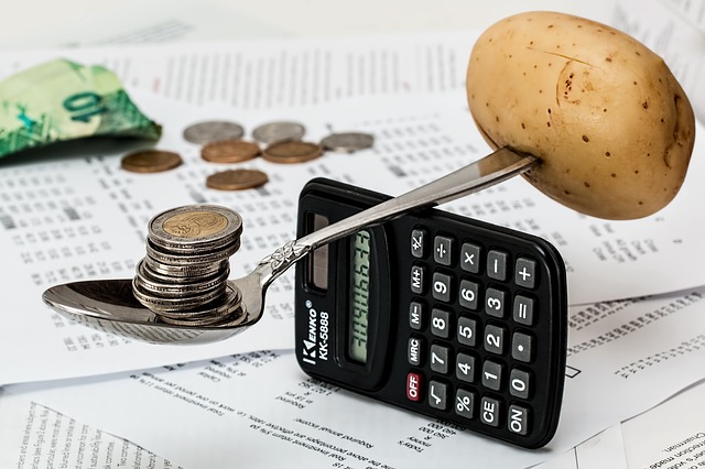 a calculator and coins on a paper
