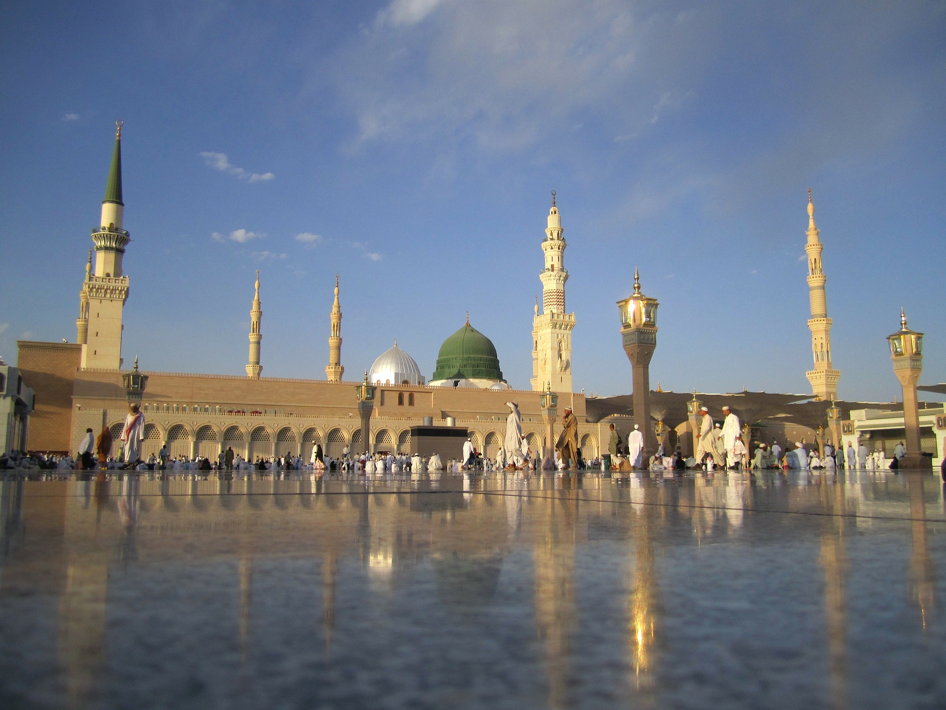 a large building with towers and domes with Al-Masjid al-Nabawi in the background