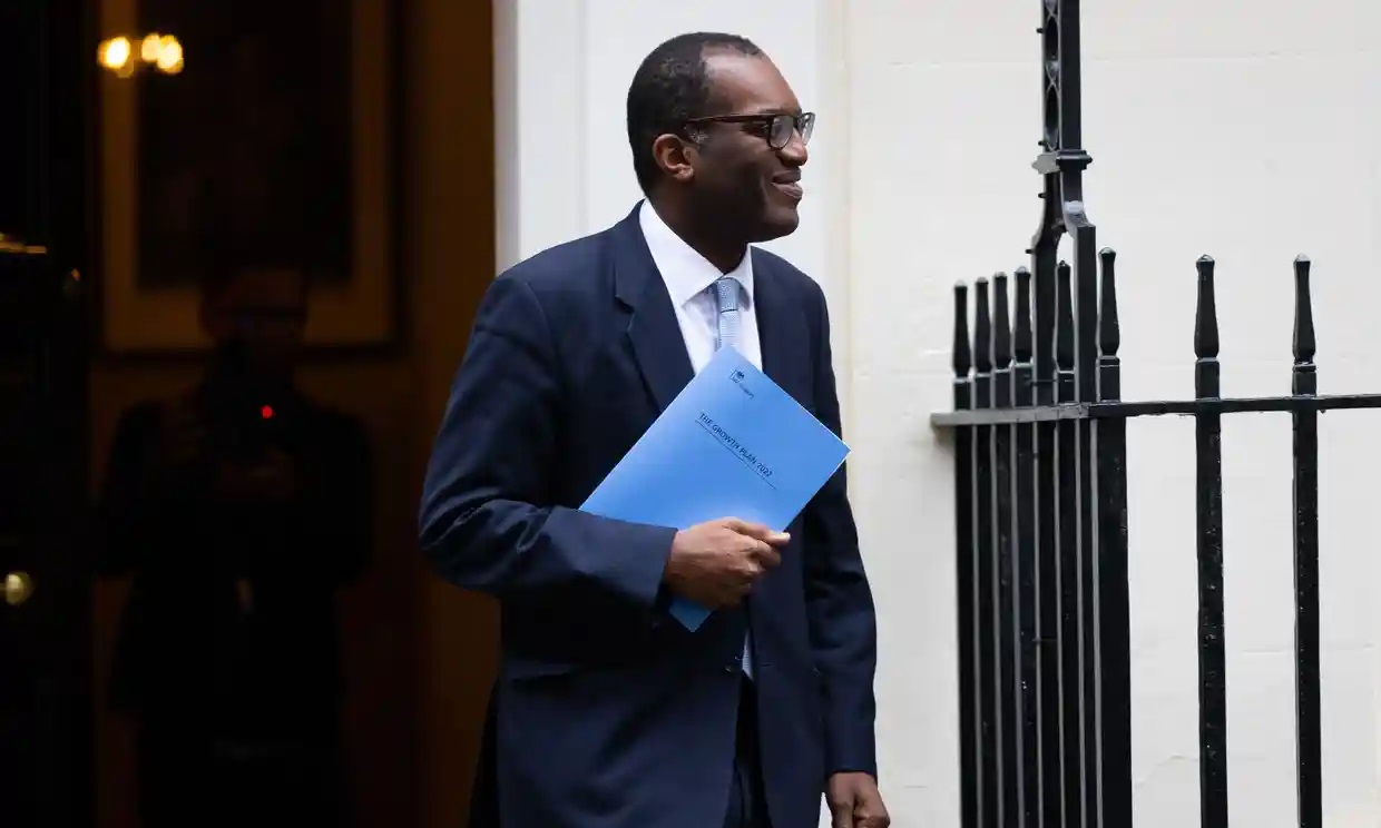 a man in a suit holding a book