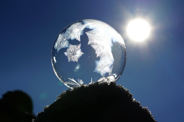 a blue globe on a rock