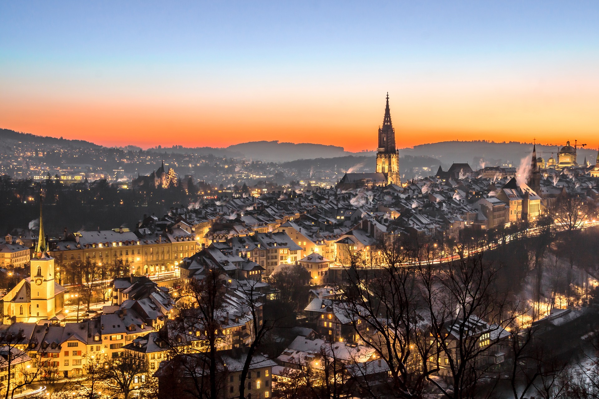 a city with a tower and a hill in the background