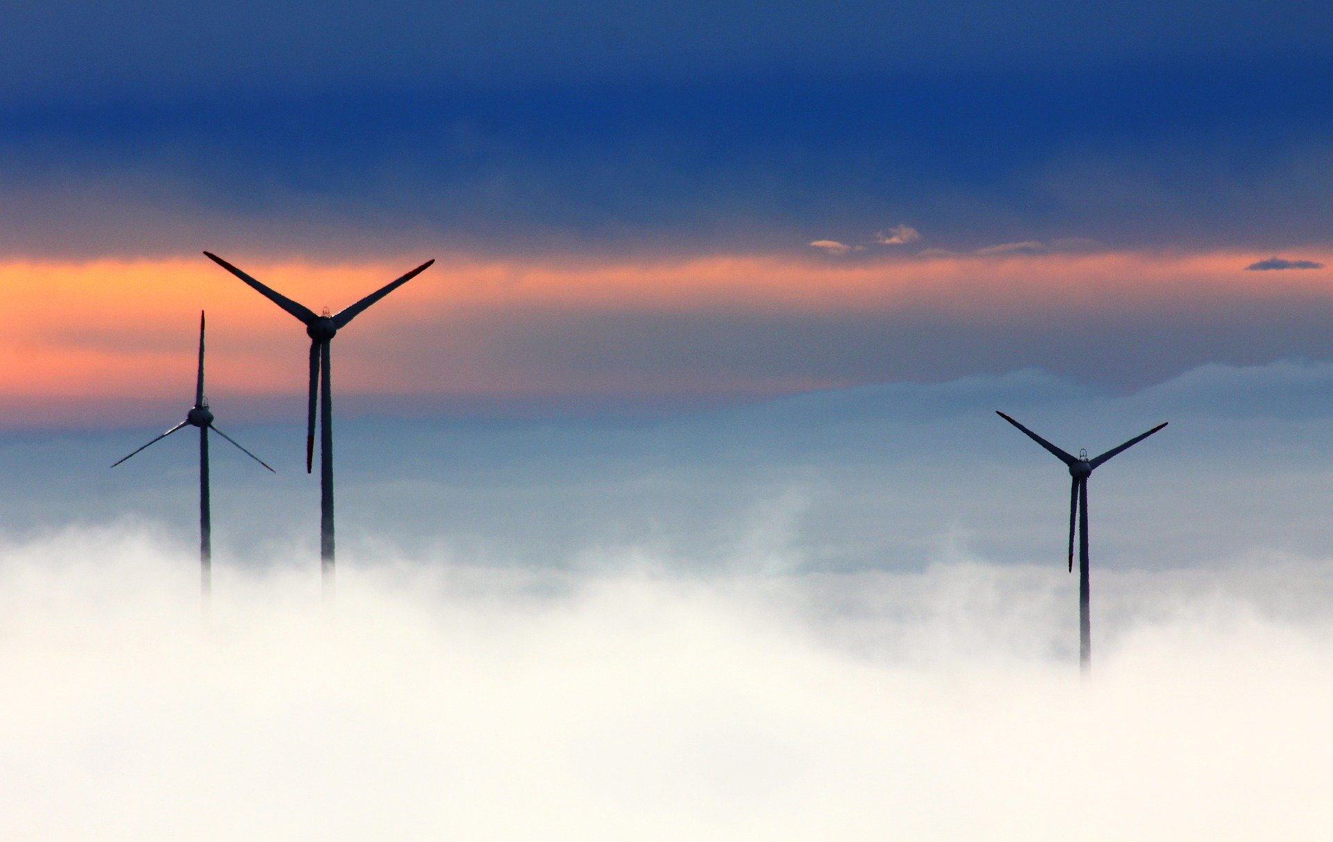 a group of wind turbines in the sky