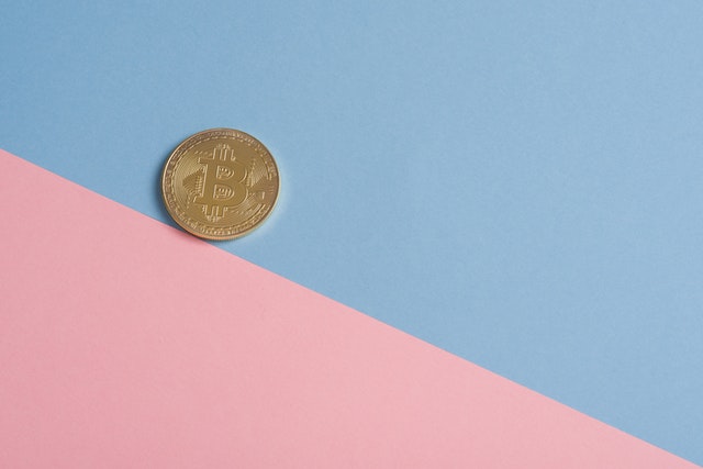a coin on a pink surface