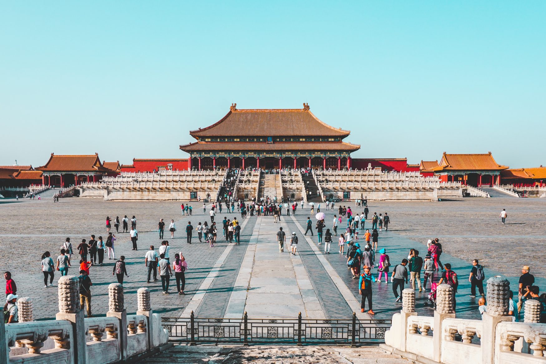 a large group of people outside a large building with Forbidden City in the background