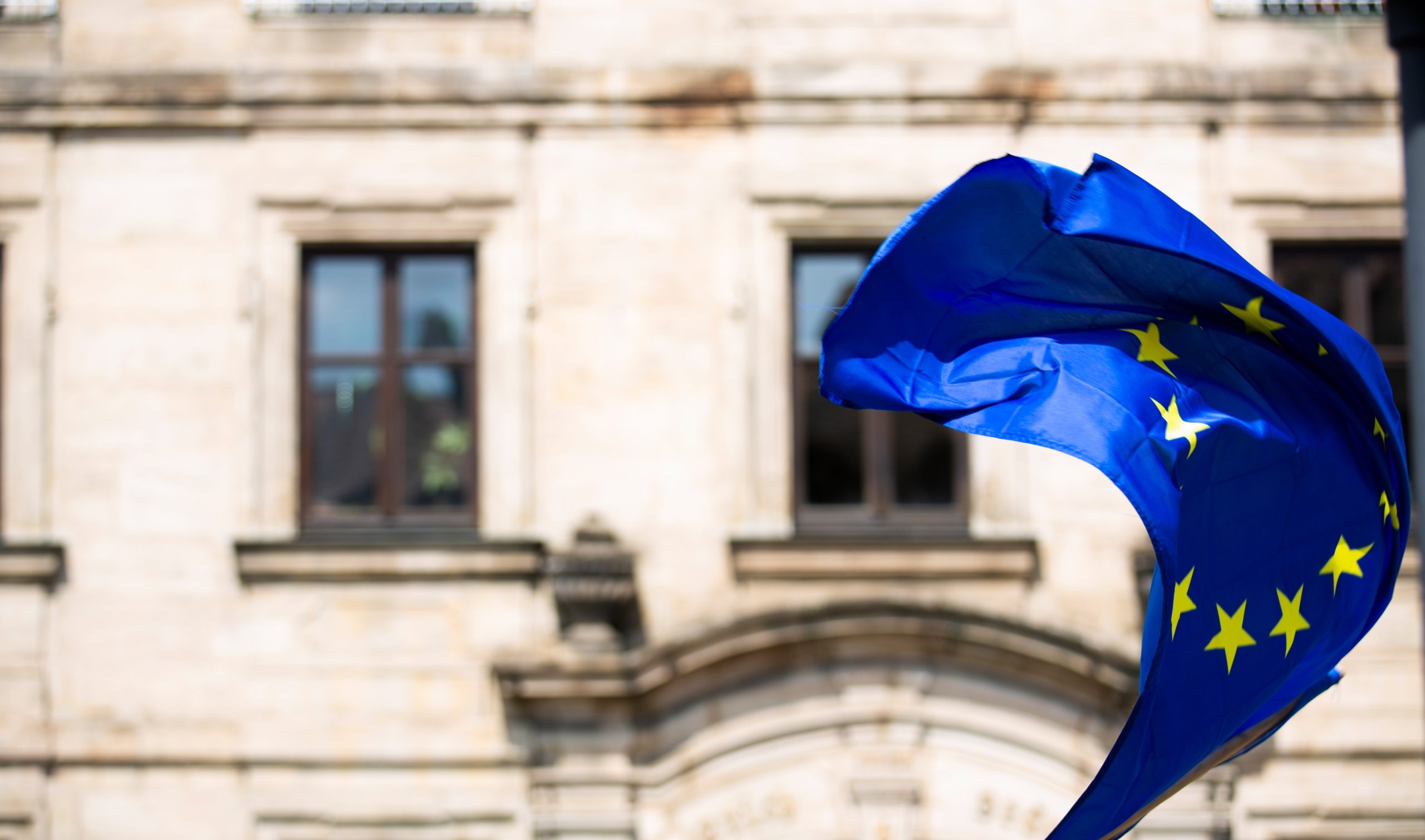 a flag flying in front of a building