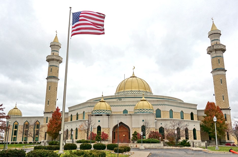 a flag flying in front of a building with towers