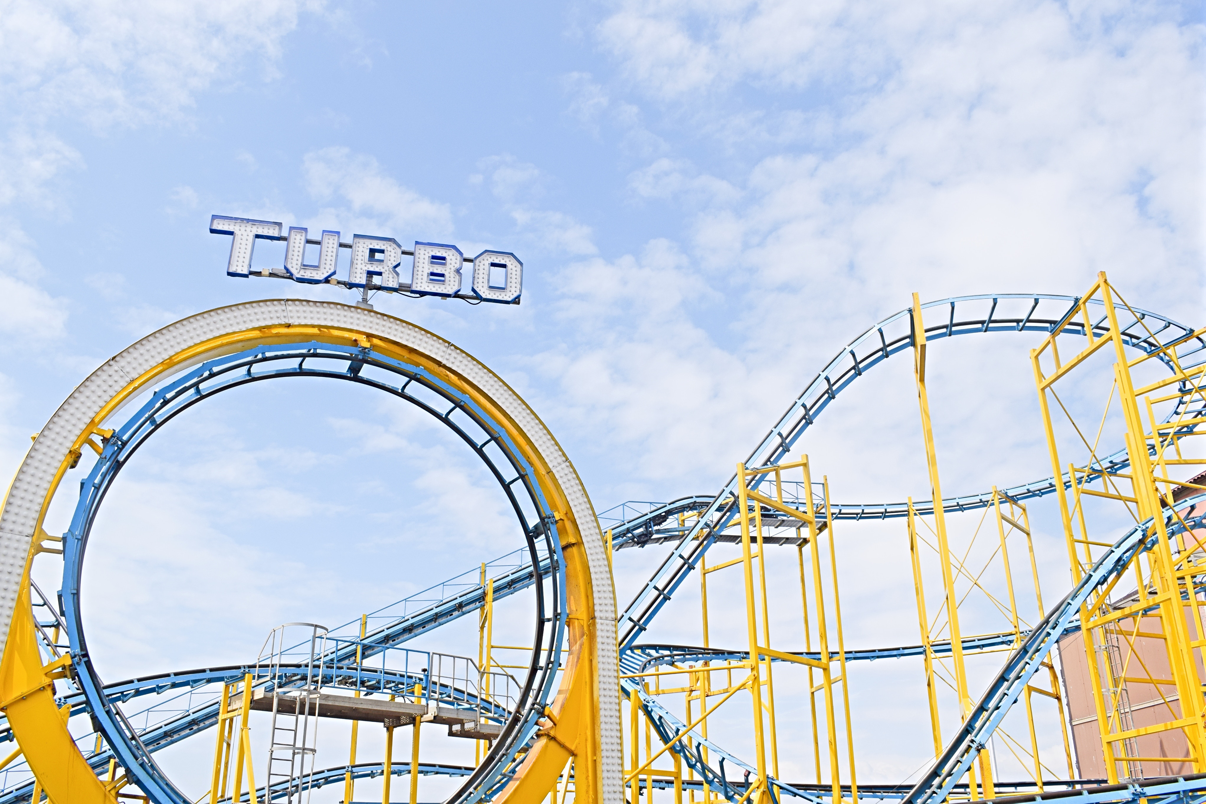a roller coaster with a cloudy sky