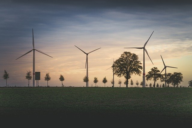 a row of windmills in a field