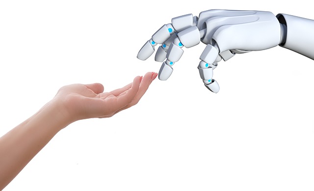 a hand holding a robotic hand