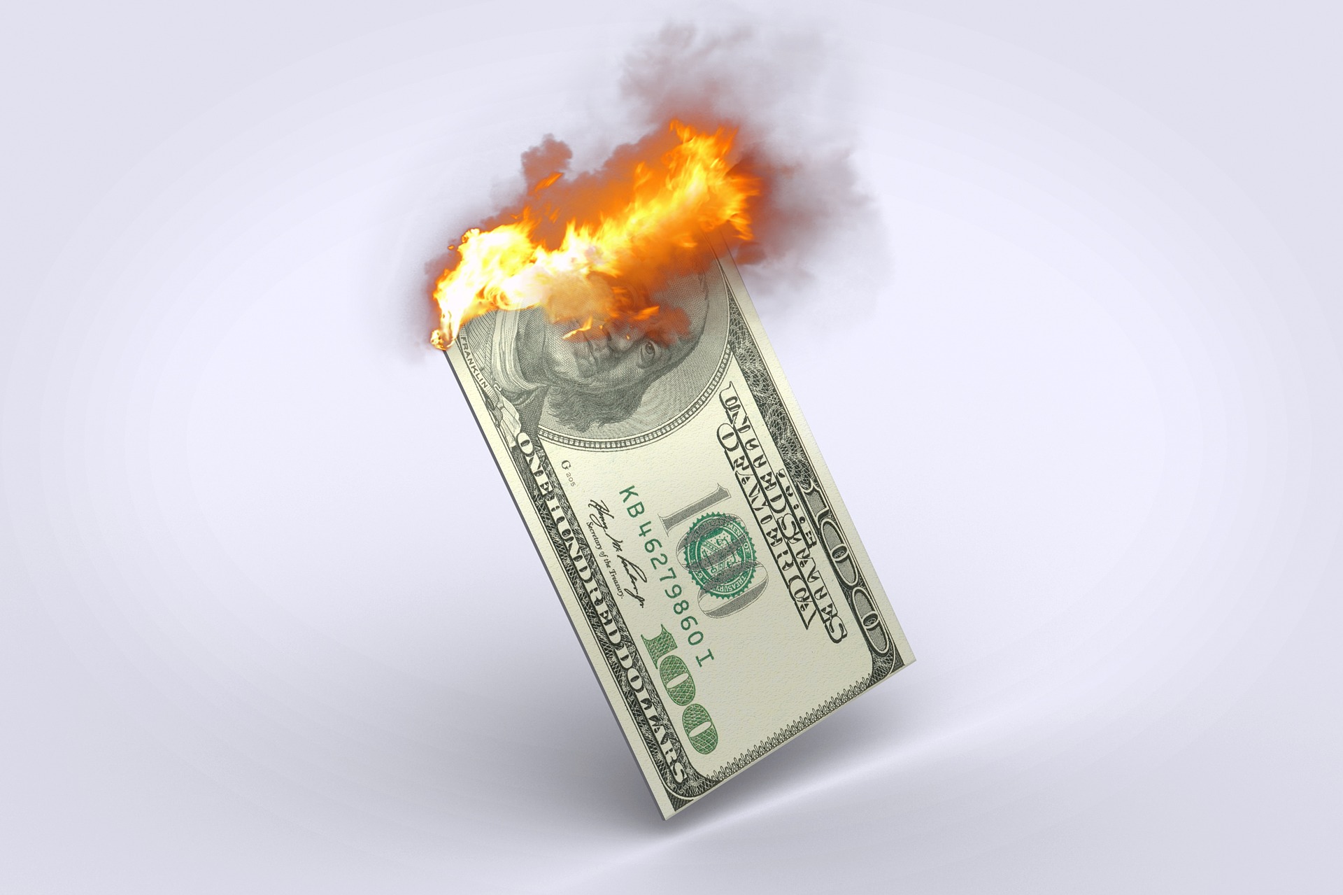 a paper with a burning dollar bill