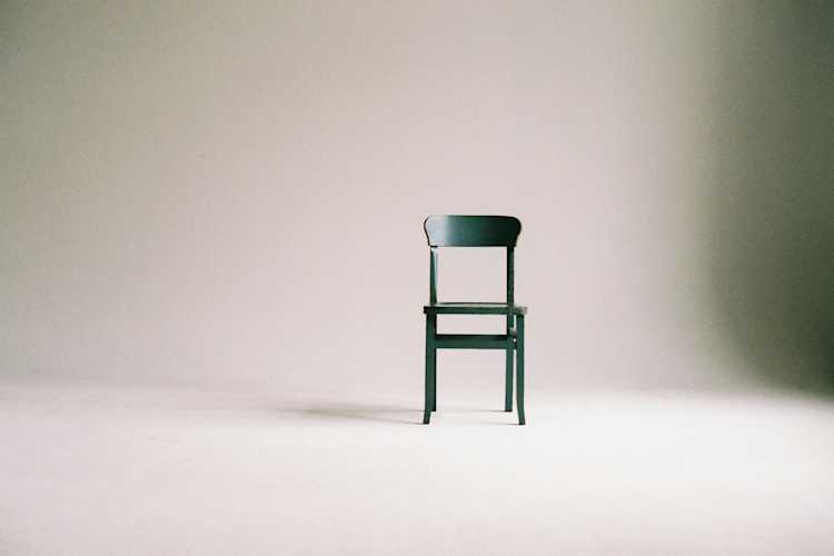 Wooden chair on a white wall studio