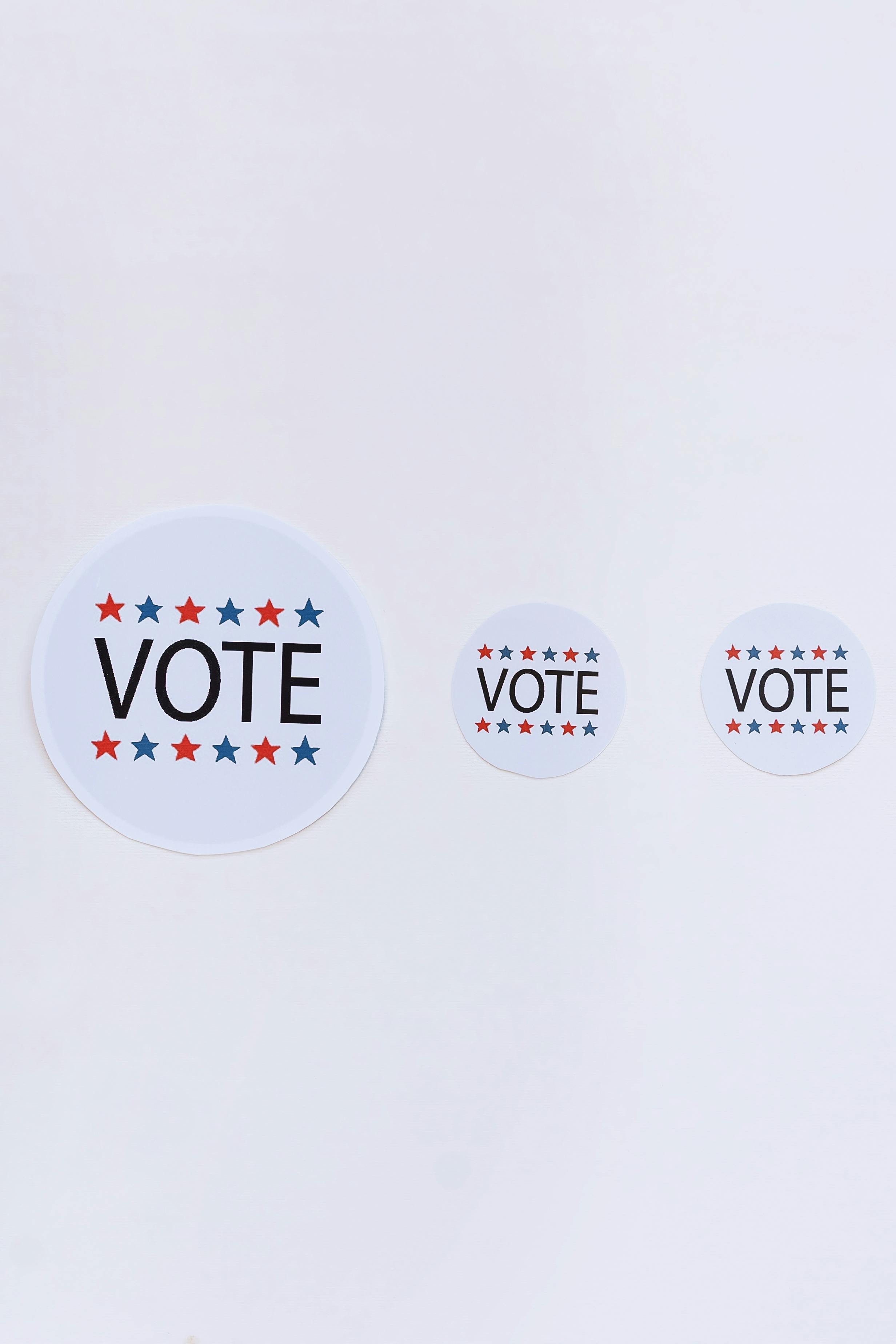 Vote badges on white surface
