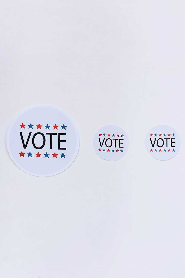 Vote badges on white surface