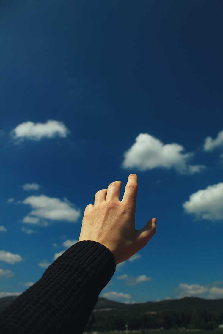 Person reaching to the sky