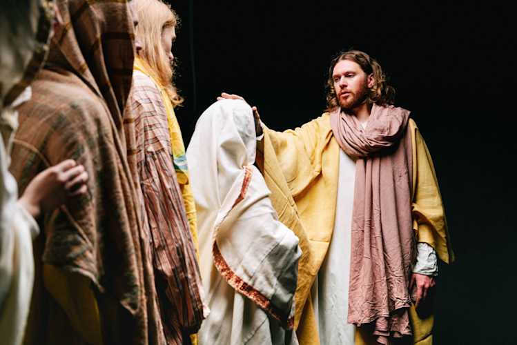 Two women and a man looking at them