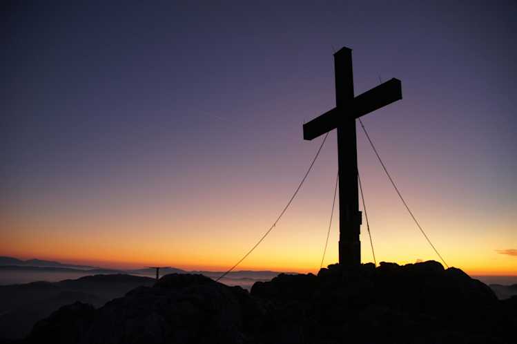 Cross silhouette during golden hour