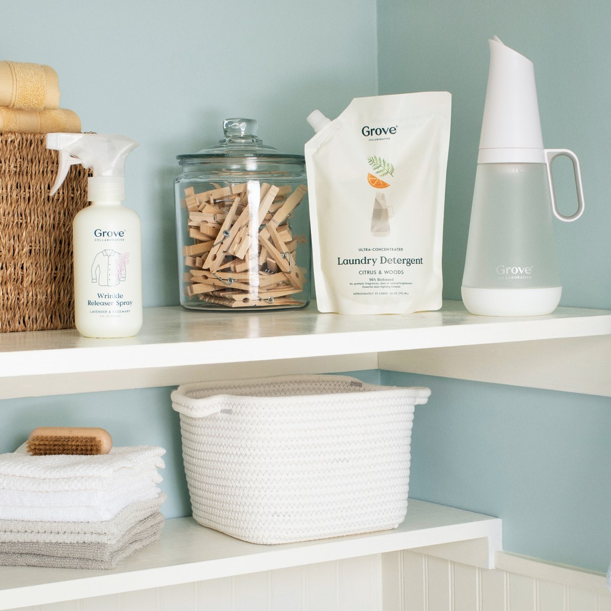 Laundry room shelves with wrinkle release spray and clothespins