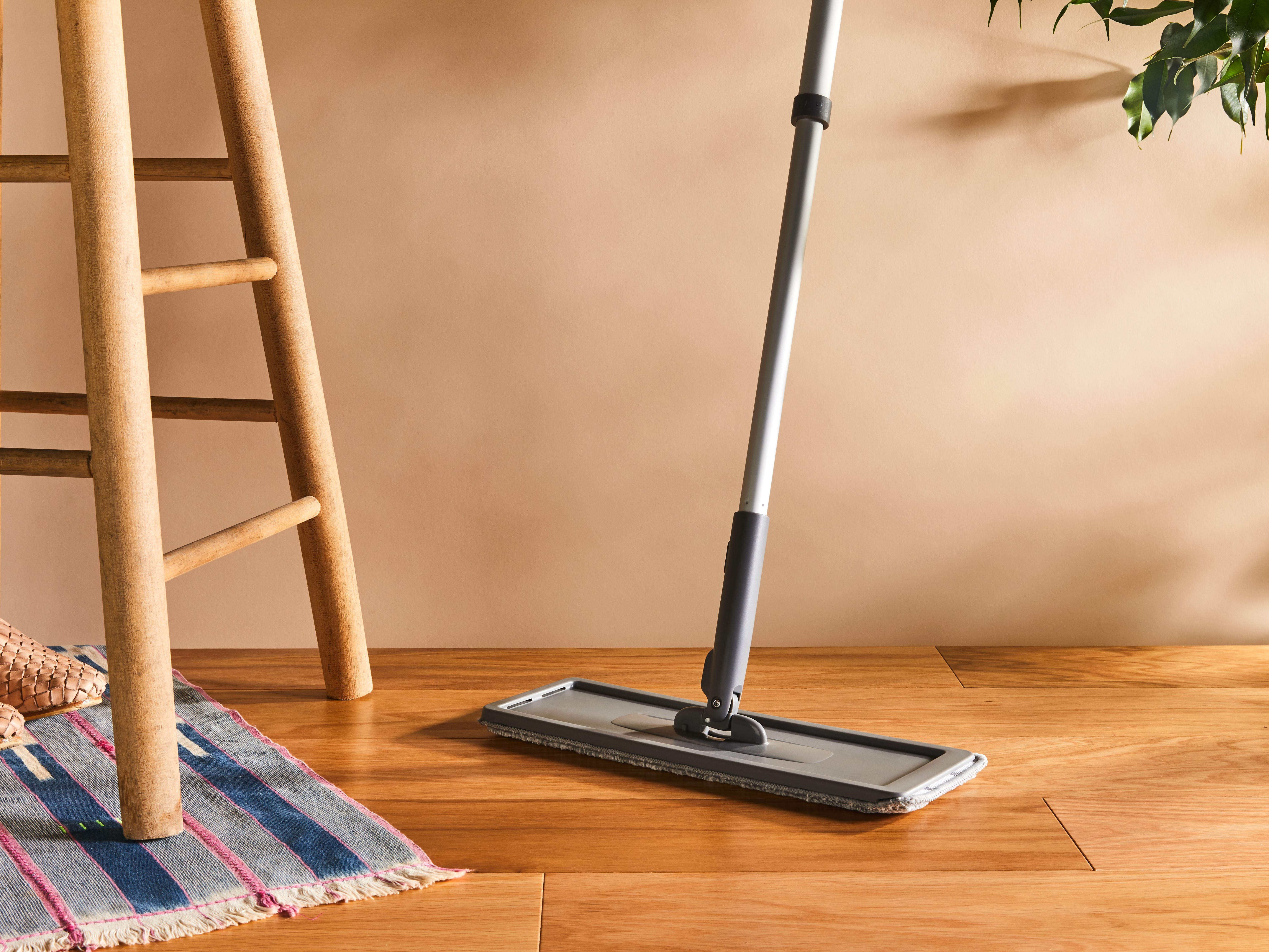 Image of dust mop on wooden laminate flooring