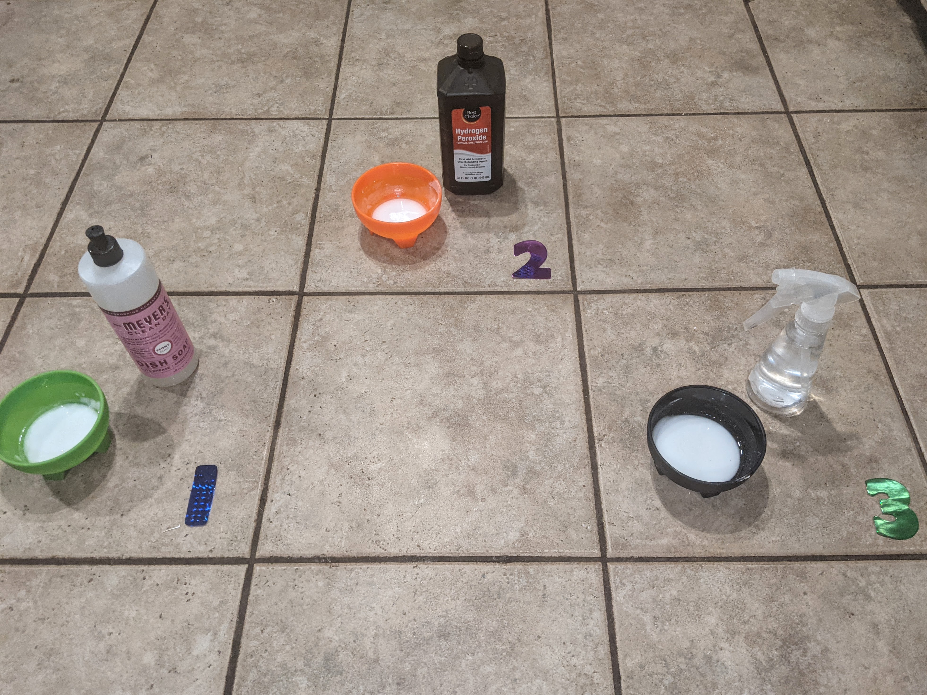 Photo of tiles with three types of cleaners placed in three different tiles