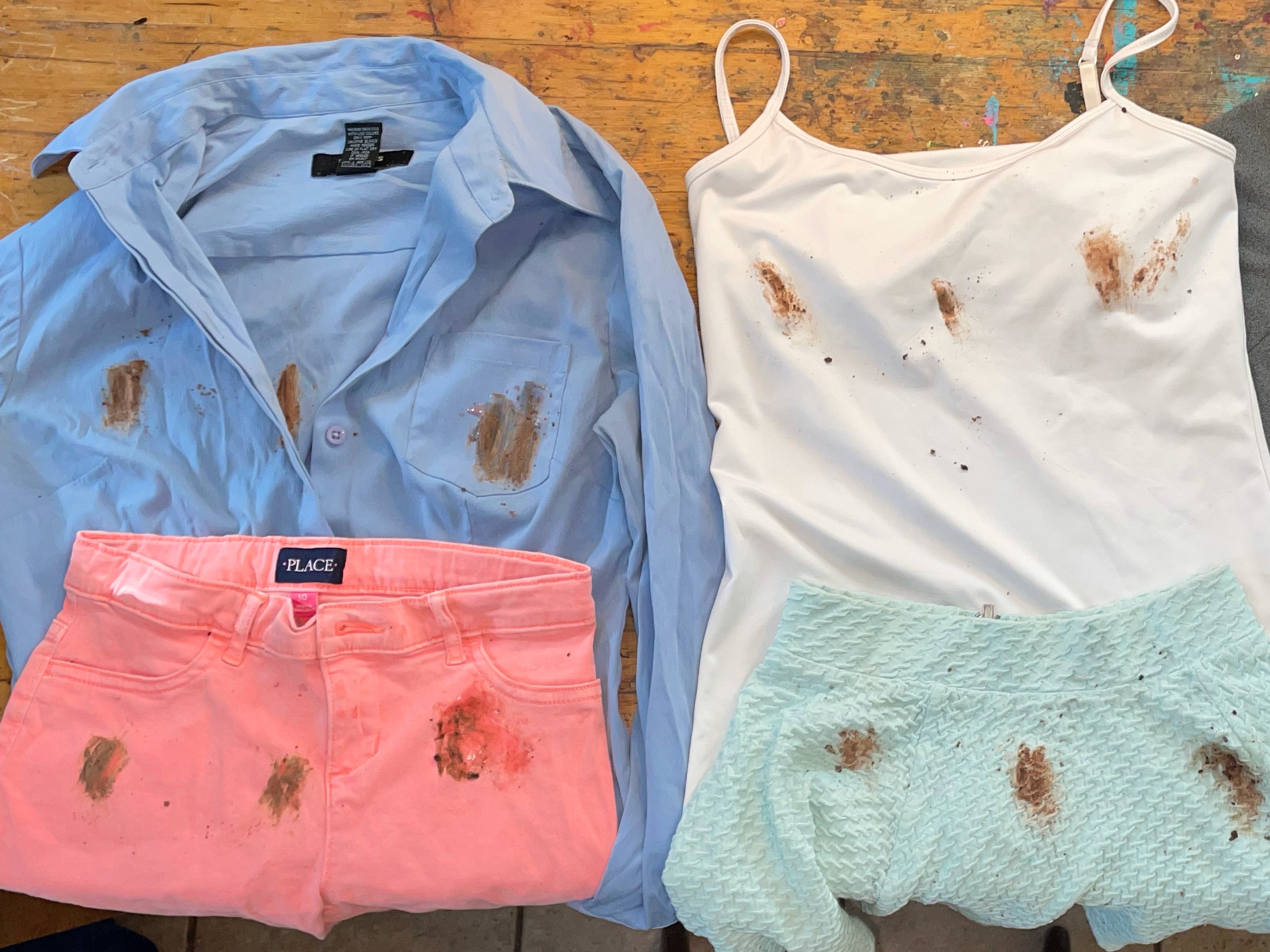 Images of shirts stained with chocolate before stain removal.