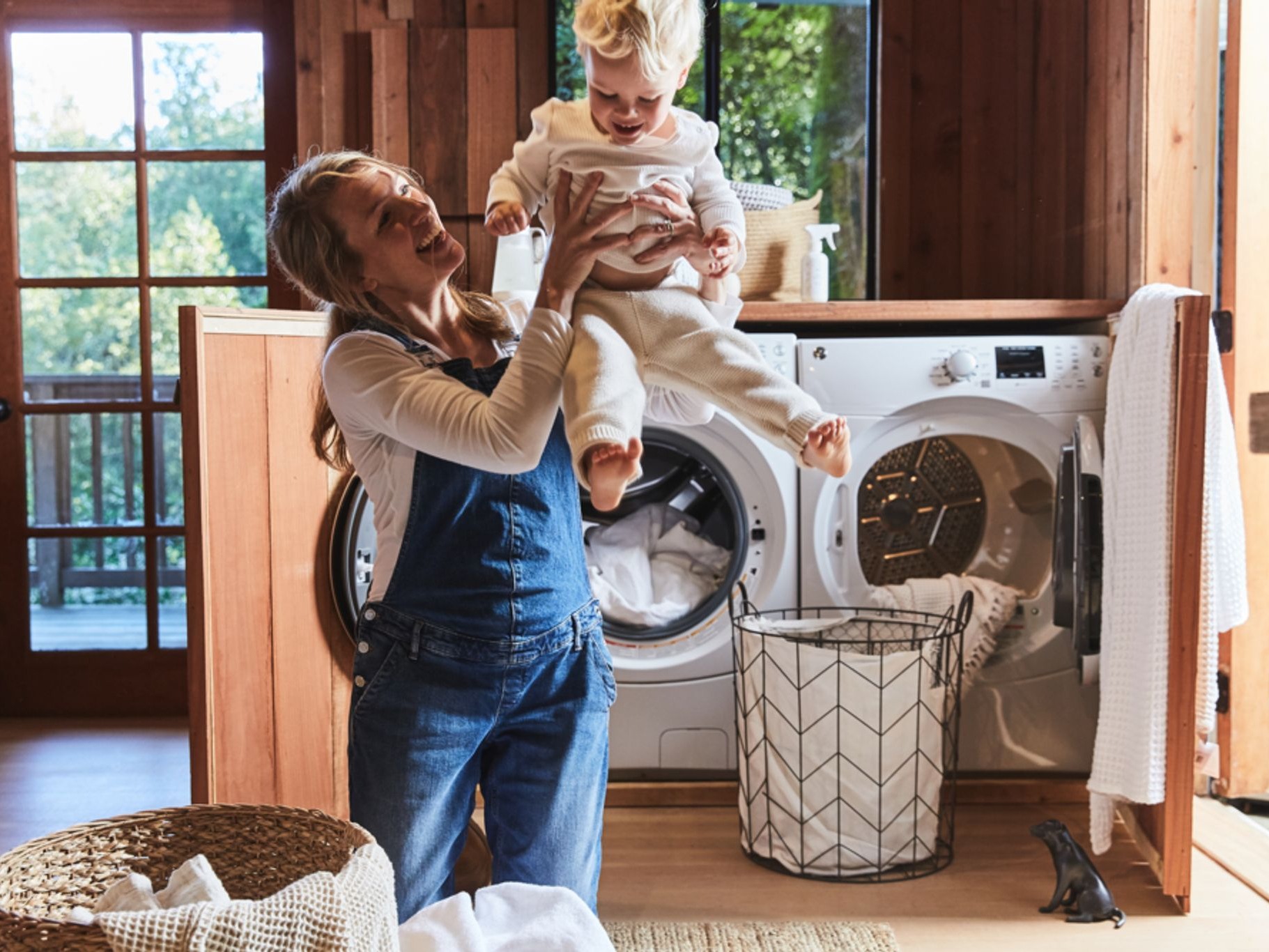 Woman holding baby in laundry room
