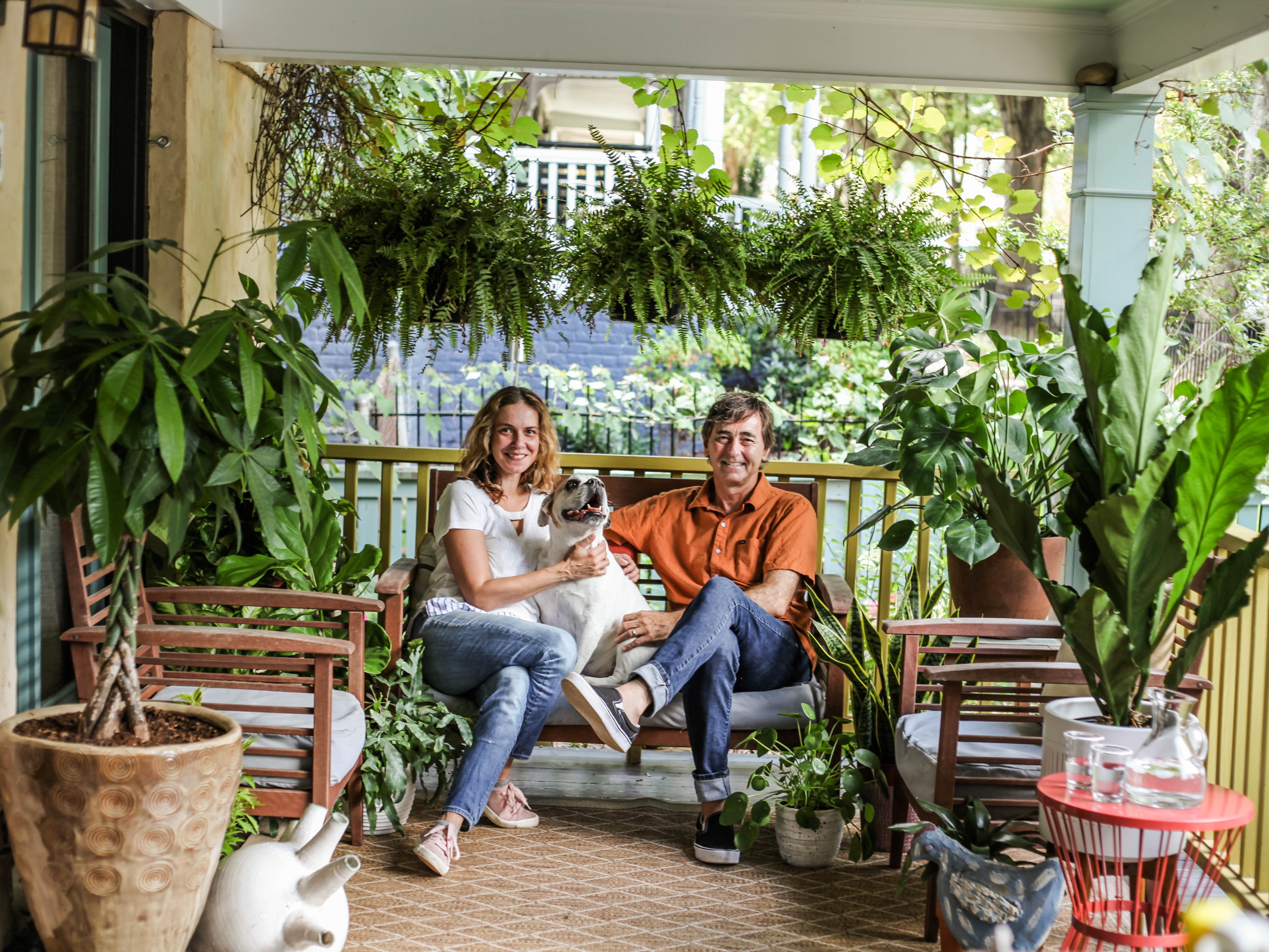 Image of Al and Suzy Newsom sitting on porch with dog