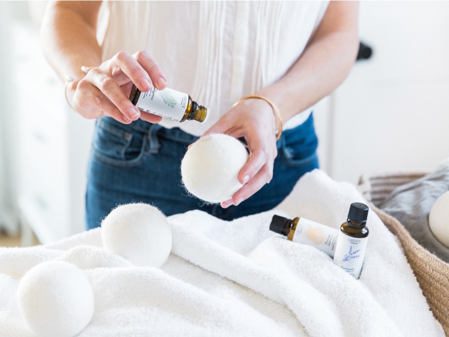 Photo of woman applying essential oil to wool dryer balls