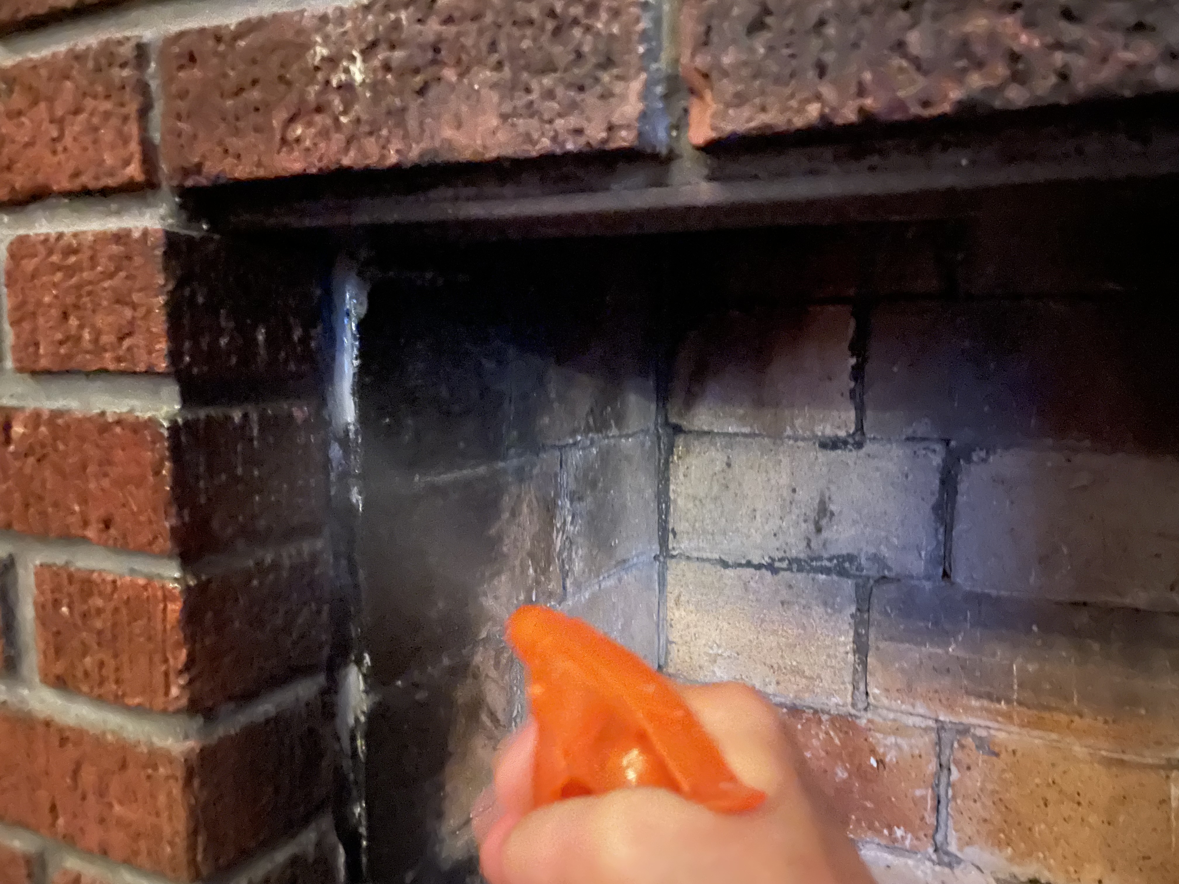 spraying the fireplace bricks to saturate them